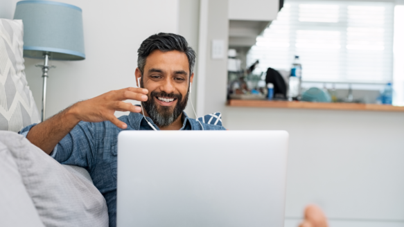 A man in his 40s smiles after booking an appointment with Money Mentors Alberta
