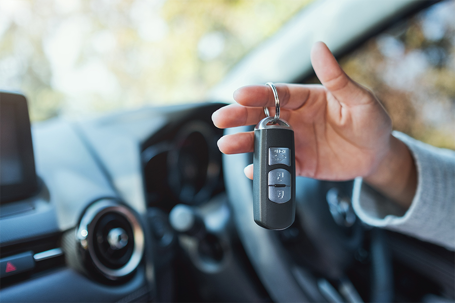 An outstretched hand holding car keys. 