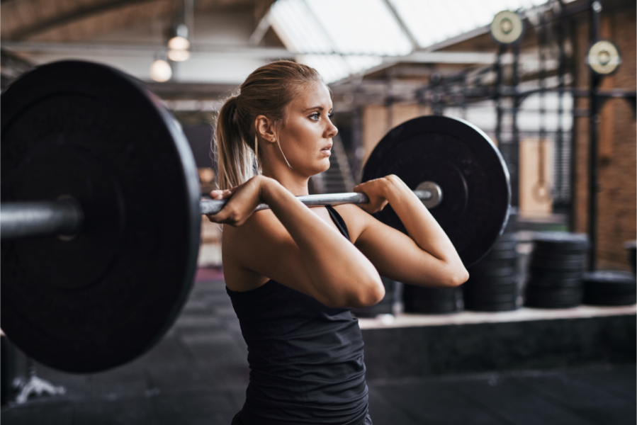 Female personal trainer lifts the weight of debt off her shoulders.