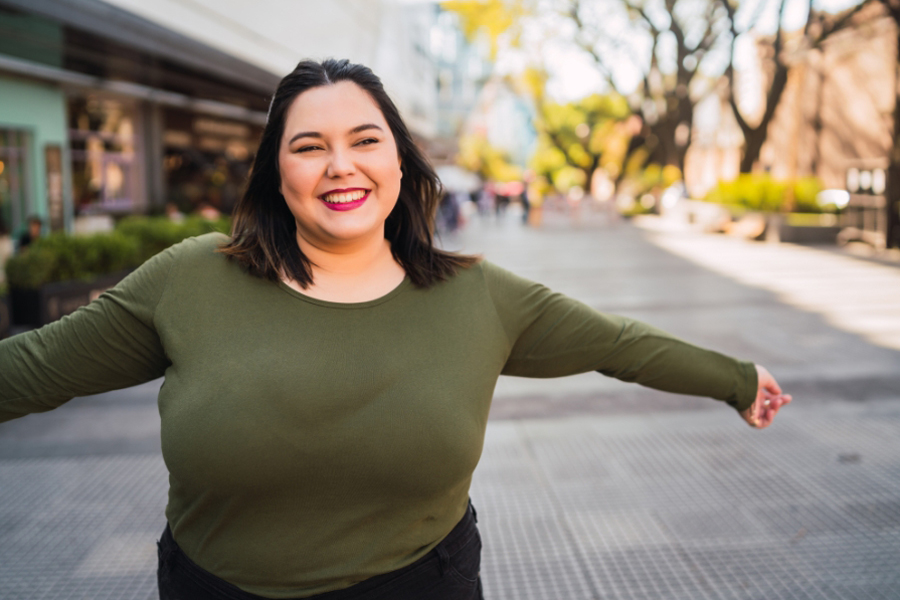 Teresa raises her arms in joy after paying off 106,000 in debt with Money Mentors 