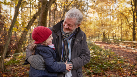 Grandfather spends time with granddaughter on an Autumn walk.