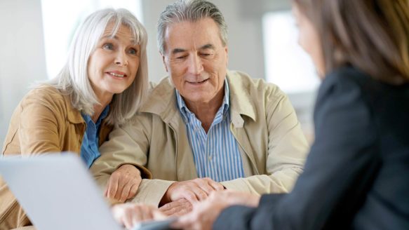 Older couple evaluating debt consolidation options to find a debt solution.
