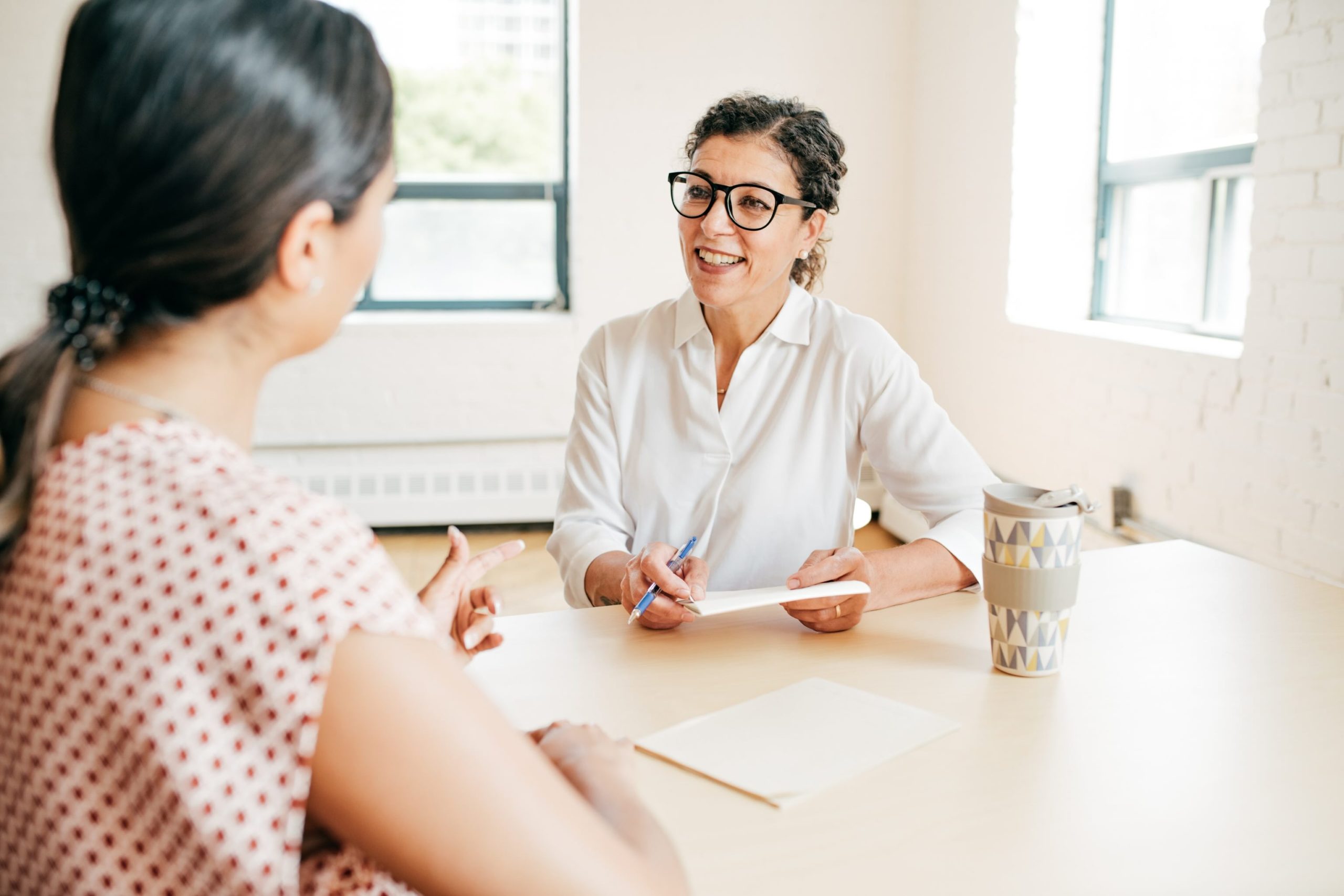 A credit counsellor discussing debt repayment options with a client, symbolizing financial guidance and relief from collection calls. 