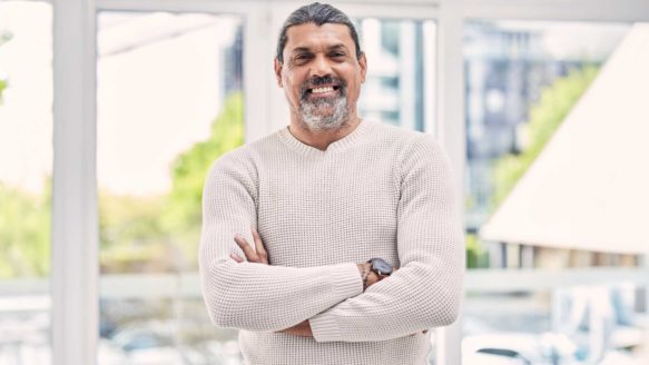 A father in Alberta smiling after overcoming $120K of debt through a debt consolidation loan, representing financial recovery and stability after divorce.