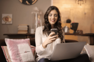 A woman monitors her spending budget on her phone