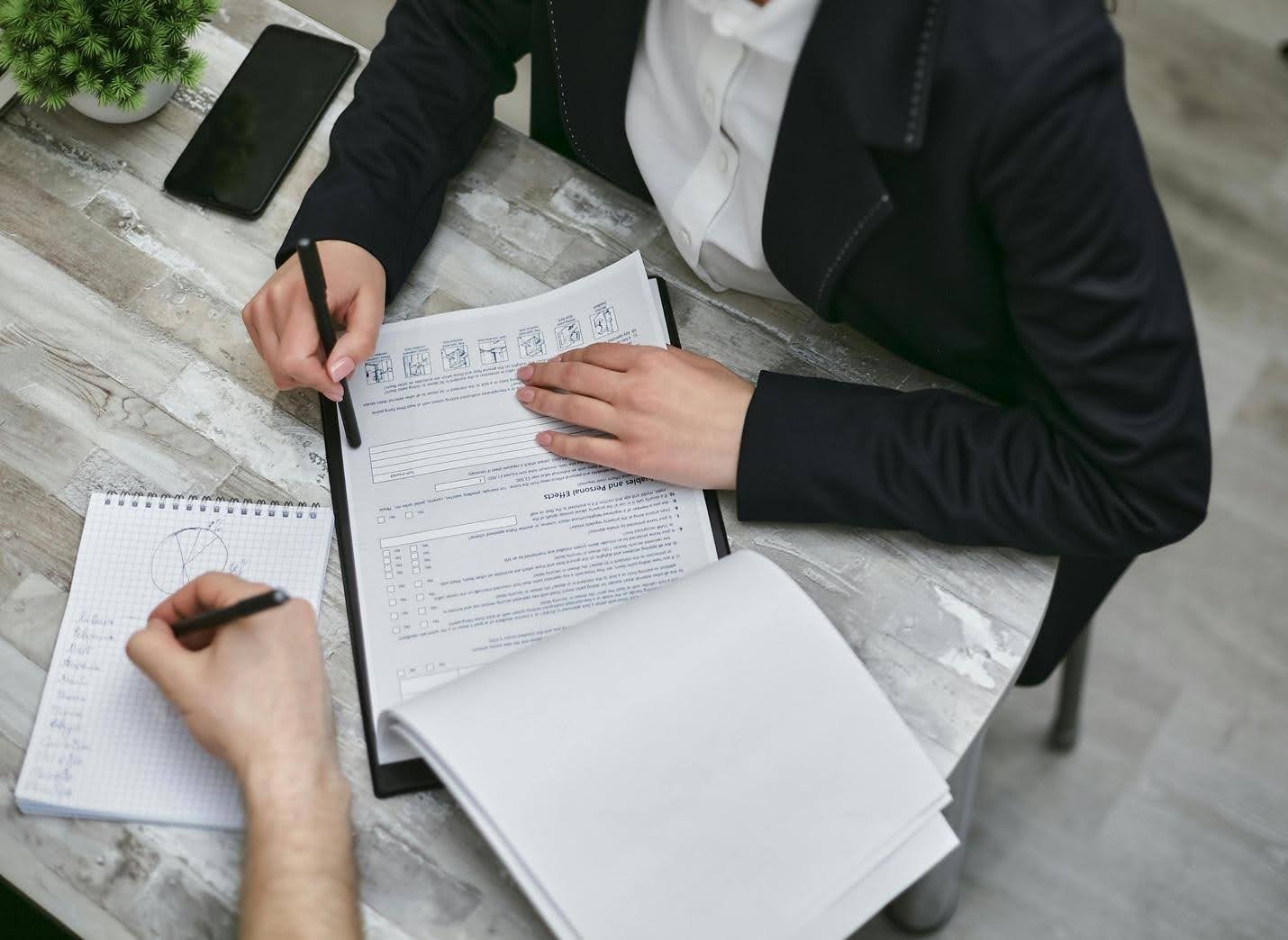 Two people at desk reviewing documents