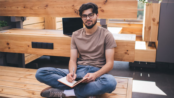 Small business owner taking a mindful break at their desk with coffee and laptop