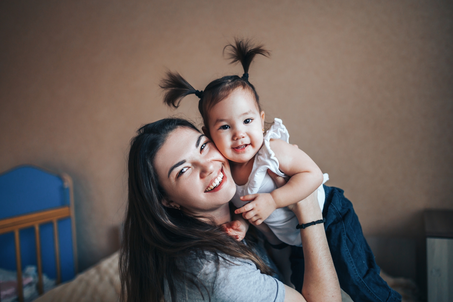 A smiling single mother holding her baby, representing hope and financial freedom after paying off $85K in debt with Alberta’s Orderly Payment of Debts (OPD) program.