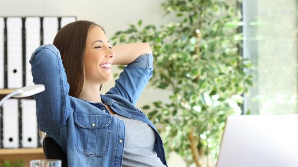 A female debt counsellor in her sunny office is proud that Money Mentors was voted the best Alberta credit counselling agency